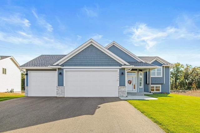 craftsman house featuring a garage and a front yard