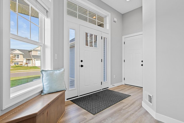 entrance foyer with light hardwood / wood-style flooring and a high ceiling