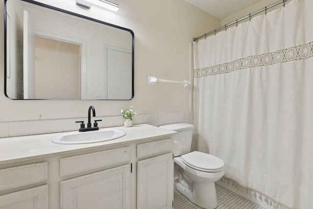 bathroom with curtained shower, toilet, vanity, and tile patterned flooring