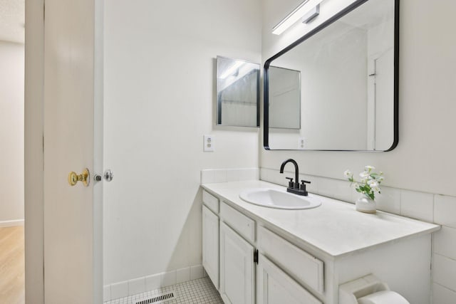 bathroom featuring baseboards and vanity