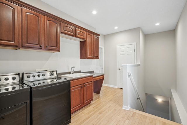 kitchen with baseboards, recessed lighting, a sink, and light wood-style floors