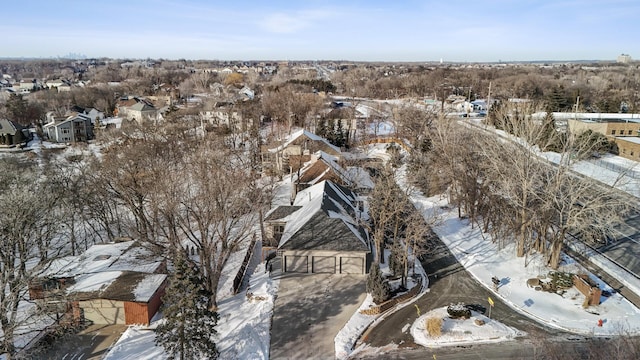 snowy aerial view with a residential view