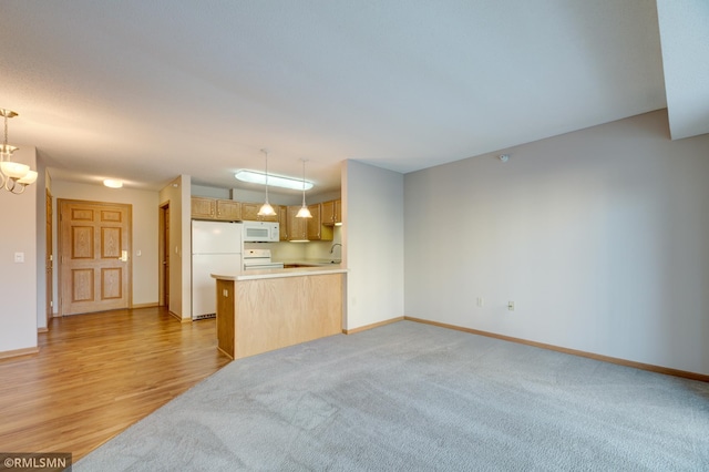 unfurnished living room with sink, light hardwood / wood-style flooring, and a notable chandelier