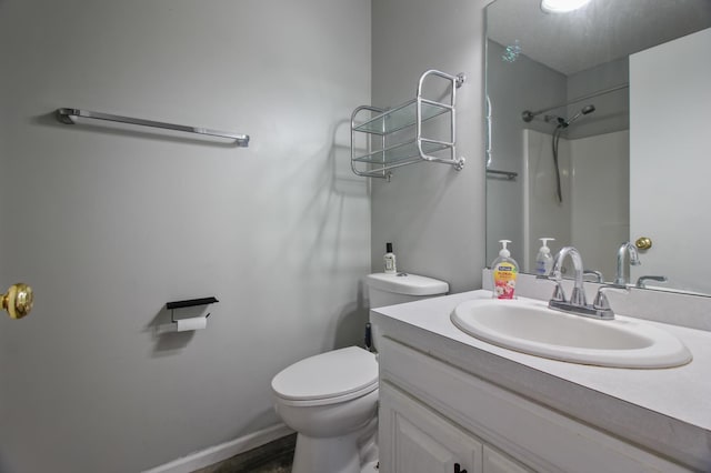 bathroom with vanity, toilet, and walk in shower