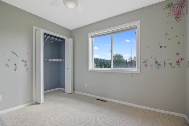 unfurnished bedroom with carpet floors and a closet