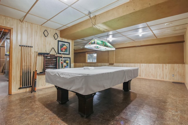 playroom with a drop ceiling and wooden walls