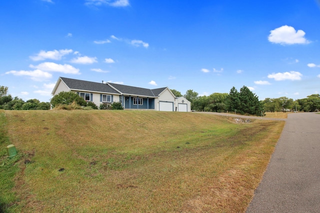 view of front of property featuring a garage and a front yard