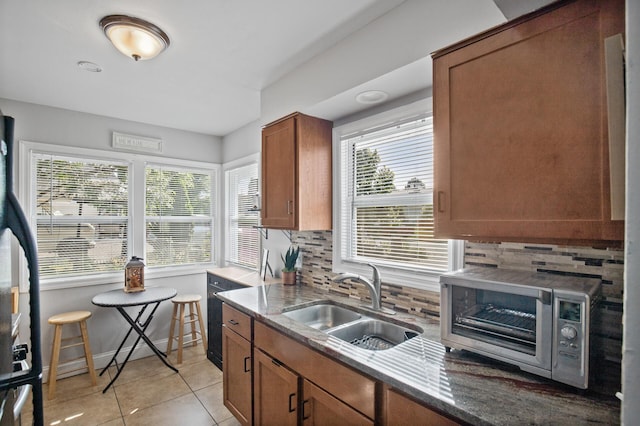 4812-4814 Idaho Ave N, Crystal, MN 55428 - kitchen with a sink, stone counters, backsplash, and brown cabinetry