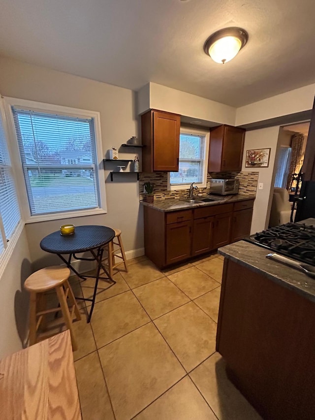 4812-4814 Idaho Ave N, Crystal, MN 55428 - kitchen with dark countertops, backsplash, light tile patterned floors, and a sink