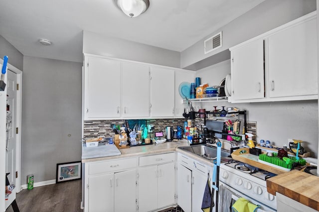 4812-4814 Idaho Ave N, Crystal, MN 55428 - kitchen with light countertops, a sink, white cabinets, backsplash, and dark wood-style flooring