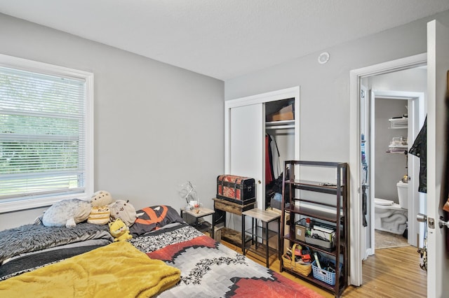4812-4814 Idaho Ave N, Crystal, MN 55428 - bedroom with multiple windows, wood finished floors, a closet, and connected bathroom