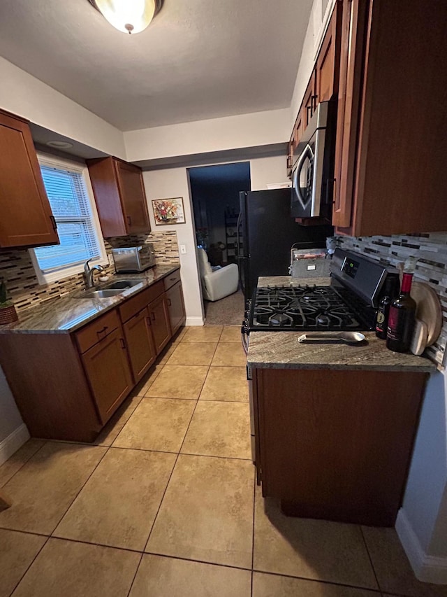 4812-4814 Idaho Ave N, Crystal, MN 55428 - kitchen featuring appliances with stainless steel finishes, a sink, tasteful backsplash, and light tile patterned floors