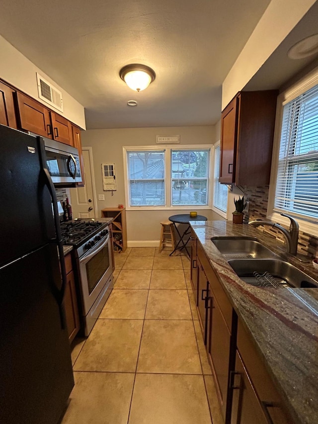 4812-4814 Idaho Ave N, Crystal, MN 55428 - kitchen with appliances with stainless steel finishes, a sink, light tile patterned flooring, and healthy amount of natural light