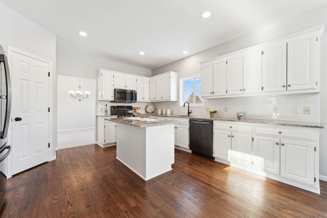 kitchen featuring black dishwasher, white cabinets, a kitchen island, stainless steel microwave, and stove