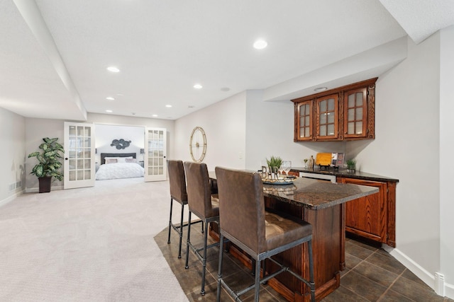 dining area with baseboards, french doors, and recessed lighting