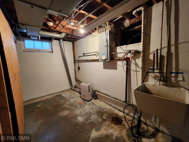 basement featuring sink and electric panel