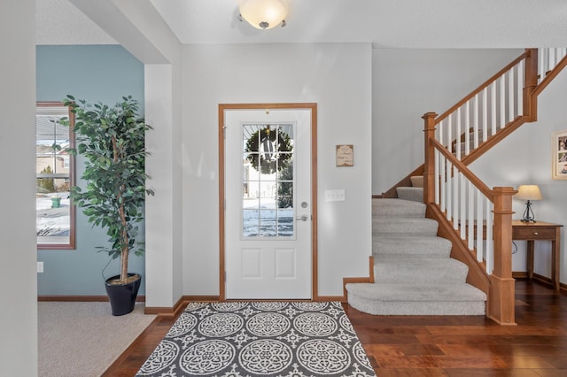 foyer with dark hardwood / wood-style floors