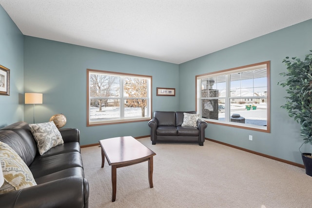 living room with a healthy amount of sunlight, light carpet, and a textured ceiling