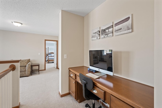 office with light carpet and a textured ceiling