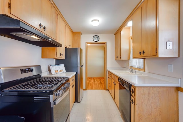 kitchen with stainless steel gas stove, under cabinet range hood, a sink, black dishwasher, and light countertops