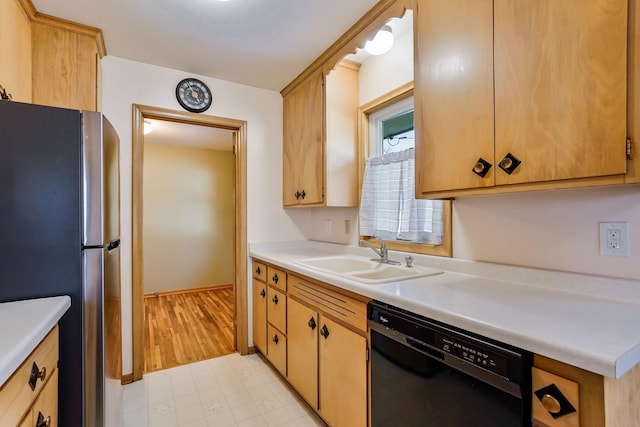 kitchen featuring baseboards, dishwasher, light countertops, freestanding refrigerator, and a sink