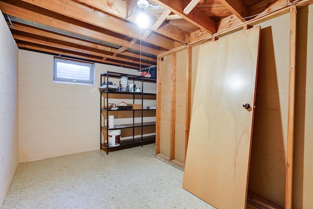 below grade area featuring tile patterned floors and concrete block wall