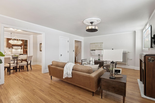 living room featuring light hardwood / wood-style flooring and a notable chandelier