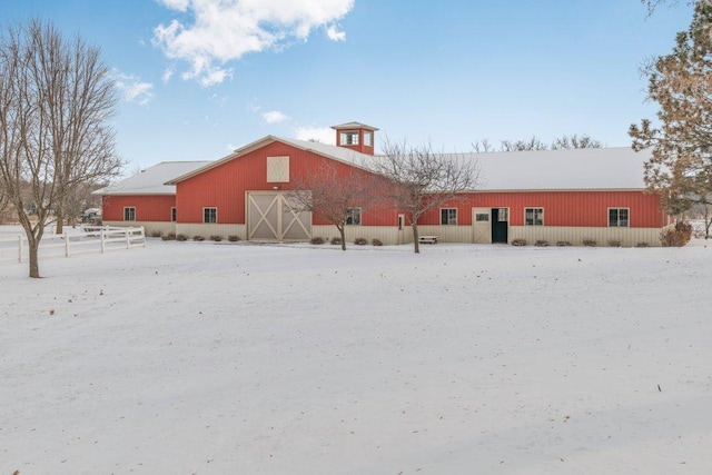 view of snow covered back of property