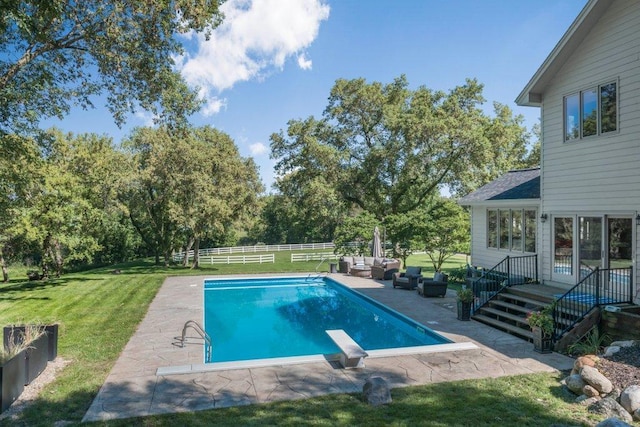 view of pool with a yard, an outdoor hangout area, a diving board, and a patio