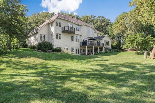 rear view of property featuring a lawn