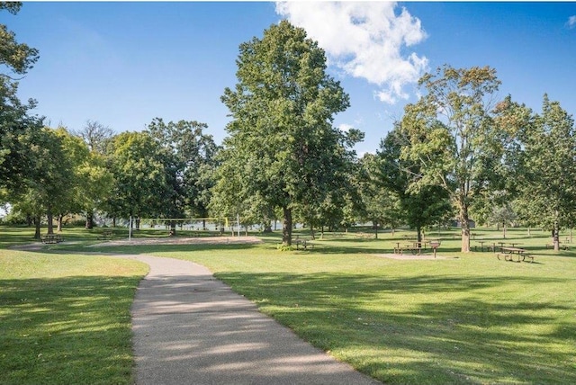 view of home's community featuring a lawn and volleyball court