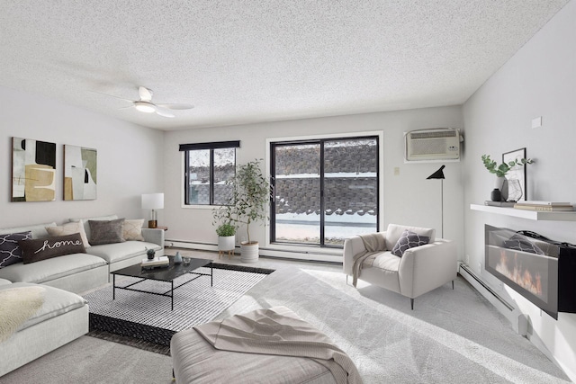 carpeted living area with a glass covered fireplace, a baseboard radiator, baseboard heating, a textured ceiling, and an AC wall unit