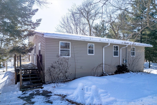 view of snow covered back of property