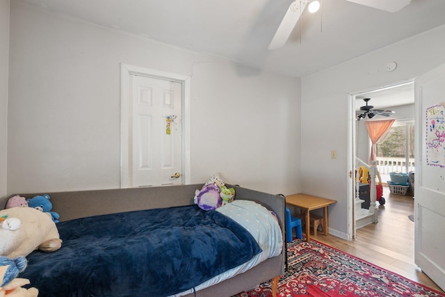 bedroom with ceiling fan and wood finished floors