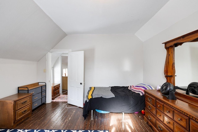 bedroom with dark wood-style floors and vaulted ceiling