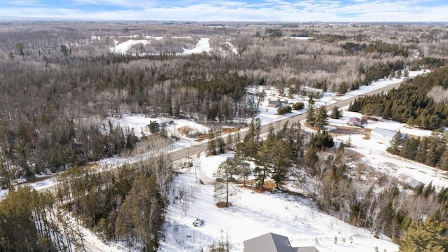 snowy aerial view with a view of trees