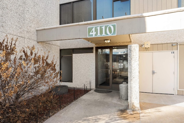 view of exterior entry featuring stucco siding