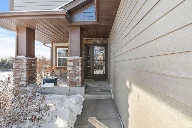 view of snow covered property entrance