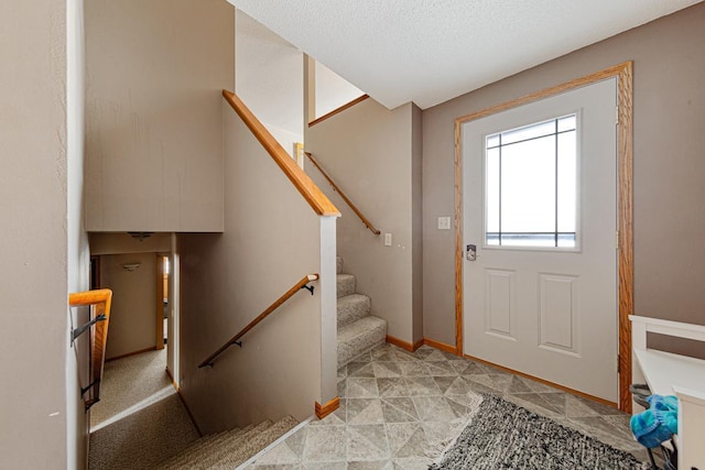 entrance foyer featuring a textured ceiling