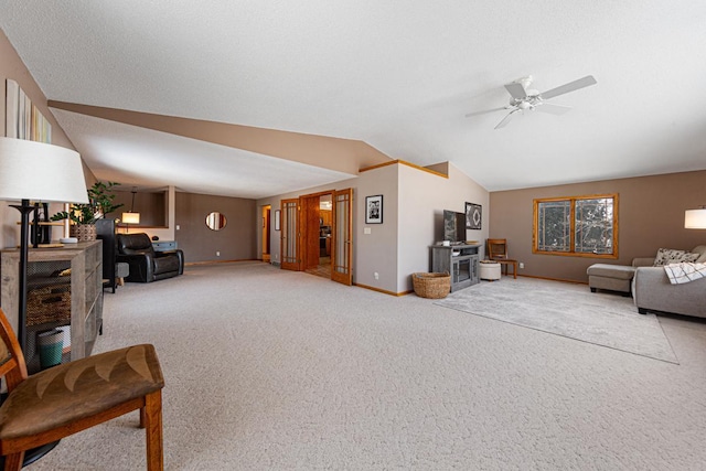 carpeted living room featuring lofted ceiling, a textured ceiling, and ceiling fan