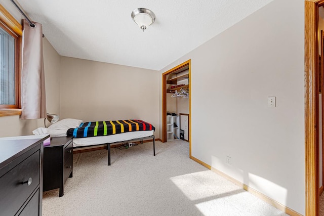 bedroom featuring light colored carpet and a closet