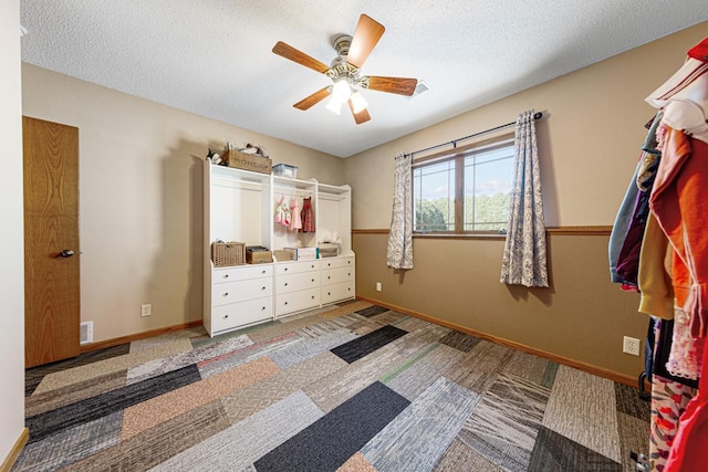 bedroom with ceiling fan and a textured ceiling