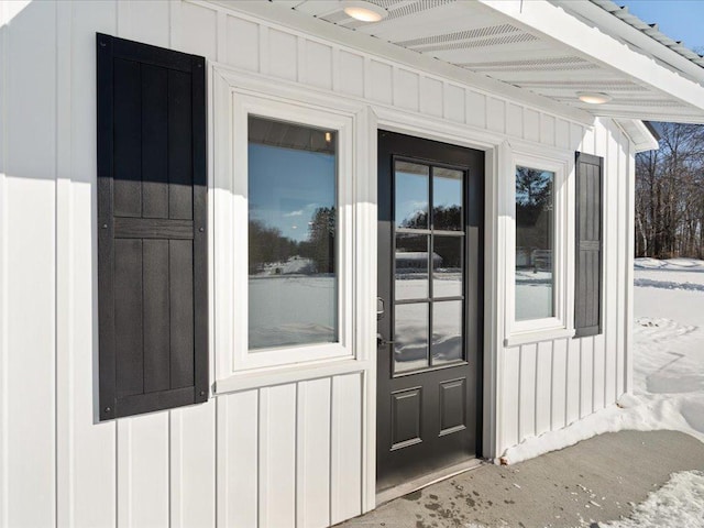 view of snow covered property entrance