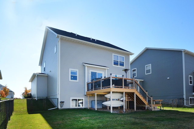 back of property with a wooden deck and a yard