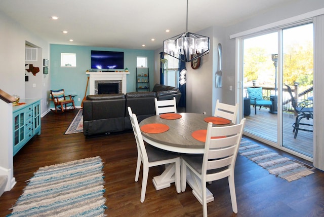 dining area with a chandelier and dark hardwood / wood-style flooring