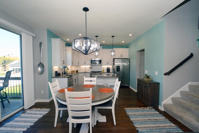 dining area with dark hardwood / wood-style flooring and sink