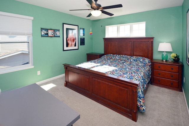 bedroom with light carpet and ceiling fan