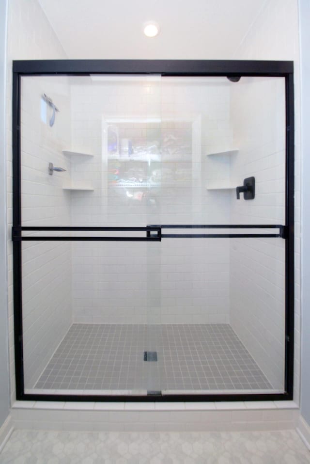 bathroom with a shower with shower door