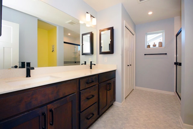 bathroom featuring vanity and an enclosed shower