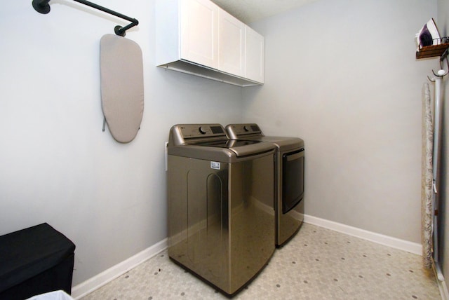 washroom with cabinets and separate washer and dryer